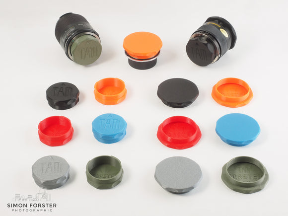 Assorted Forster UK TAMRON adaptall and adaptall2 mount rear lens caps and front caps in various colours on a white backdrop.
